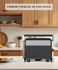 4 Slice Panini Press Contact Grill With Removable Non Stick Coated Plates Temperature Control Timer And Open 180 Degree Design For Cooking Sandwiches Steaks Sausages Quesadillas Half Black Stainless Steel Finish in upright storage position on kitchen counter.