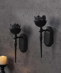 Kick Up Your Living Room Vibe With These Dope Black Gothic Wall Sconces Set Of Two Handcrafted Iron Crown And Scepter Candle Holders For Vintage Home Decor Style  black iron sconces mounted on a textured wall with taper candles.