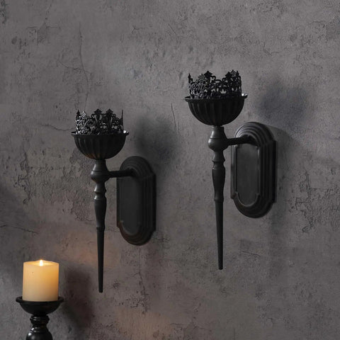 Kick Up Your Living Room Vibe With These Dope Black Gothic Wall Sconces Set Of Two Handcrafted Iron Crown And Scepter Candle Holders For Vintage Home Decor Style  black iron sconces mounted on a textured wall with taper candles.