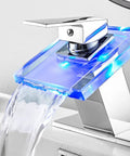 Waterfall Glass Spout LED Temperature Changing Bathroom Faucet With Single Handle Deck Mounted Cold Warm Hot Water Mixer Chrome Finish Four Color Modes And Temperature Warning Light with blue LED glowing.