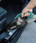 Cordless Vacuum For Workshop And Home, 18V LXT Tool Only, shown cleaning car interior, ergonomic design in use.