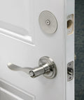 Installed Steel Door Hole Cover Plate Gray 2-5/8 Inch Diameter on white door concealing unused knob holes for privacy and security