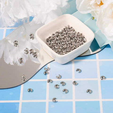 Stainless Steel Crimp Bead Covers 6x5x3mm Half Round Clamp Tips Pro Grade Knot Covers For Jewelry Making in a dish, 200 pieces.