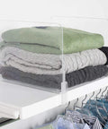 Acrylic Closet Shelf Dividers 8 Pack Clear Organizer for Purses and Sweaters Keeps Your Closet Neat and Accessible Space Saving Shelf Separators Adjustable up to 2.5 Inches Thick on shelf with folded sweaters.
