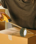 Person using Plaid Pattern Shipping Tape 2 Rolls Adhesive Sealing Packing Tape With Black Yellow Grid Design on cardboard box
