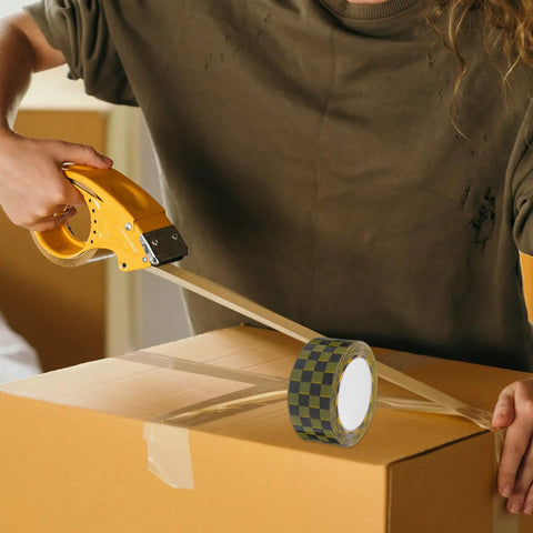 Person using Plaid Pattern Shipping Tape 2 Rolls Adhesive Sealing Packing Tape With Black Yellow Grid Design on cardboard box