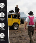 Person wearing pink 12L Hydration Backpack With 2L Water Bladder For Men And Women approaching yellow jeep