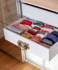 Open drawer with old school brass drawer pulls set 2 antique cabinet handles on white dresser displaying folded clothes