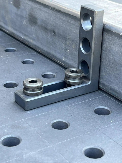 Hassle Free 5/8 Quick Release Ball Lock Pins For Modular Welding Fixture Tables 4 Pack displayed on a welding table surface.