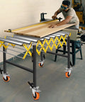 Heavy Duty 50 Inch Extendable Roller Conveyor Table With Steel Frame Loads 1000 Lbs For Warehouse, Workshop And Fulfillment Center Use in workshop with wood.