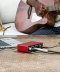 Scarlett Solo Studio 3rd Gen USB Audio Interface Bundle With Condenser Microphone And Headphones used by guitarist on sofa