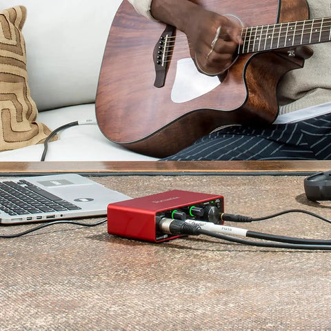 Scarlett Solo Studio 3rd Gen USB Audio Interface Bundle With Condenser Microphone And Headphones used by guitarist on sofa