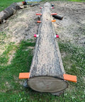 Log with Rail Mill Guide System 9 Ft With 3 Crossbar Kits For Chainsaw Mill, set for straight, level first cuts on grass.