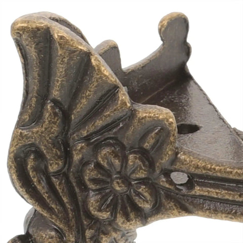 Close-up of Eight Piece Zinc Alloy Decorative Furniture Legs For Antique Boxes And Jewelry Boxes Old School Vintage Style Corner Protectors With Delicate Design.