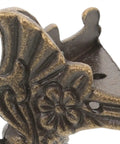 Close-up of Eight-Piece Zinc Alloy Antique Box Feet For Jewelry Boxes And Vintage Furniture in gold finish with floral detail.