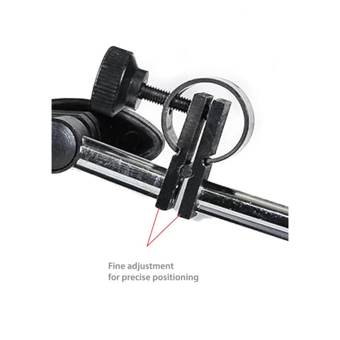 Close-up of Fowler magnetic base and black dial indicator clamp with fine-adjustment screws on a chrome rod