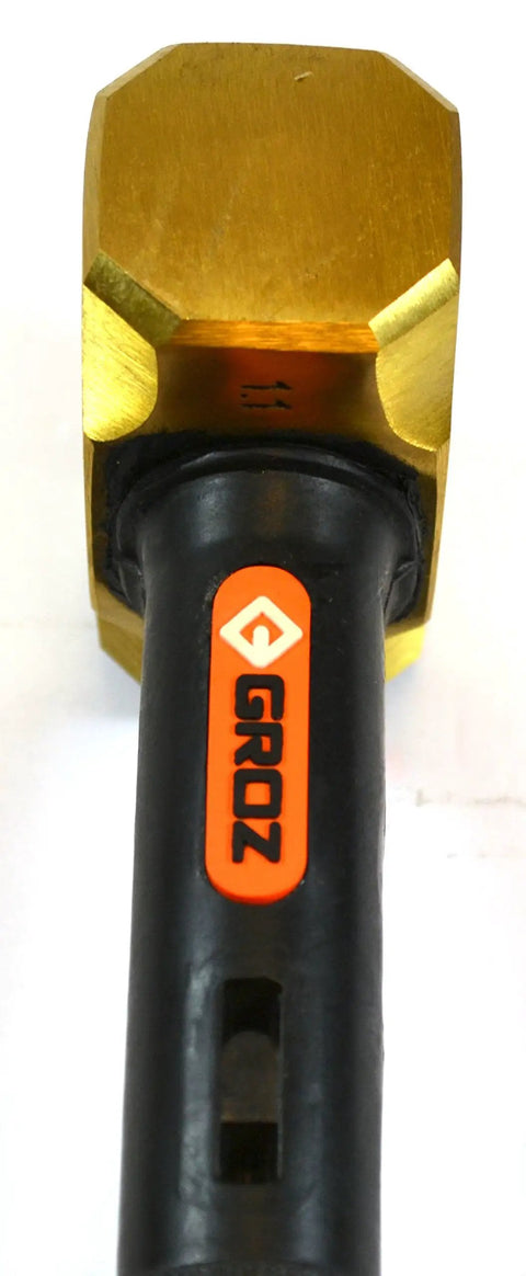 Close-up of Brass Head Sledge Hammer With Indestructible 12-Inch Handle showing brass head and rubber grip.