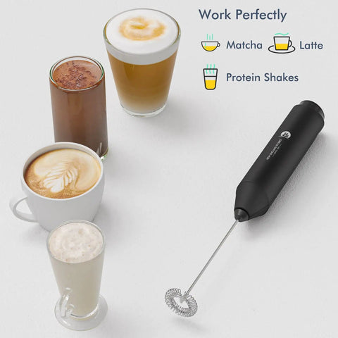 Effortless Milk Frother Handheld Foam Maker For Coffee Nerds Mini Whisk Drink Mixer For Cappuccino Latte Matcha And Hot Chocolate Includes Stand Black Cordless Battery Powered Requires Two AA Batteries Not Included next to coffee cups
