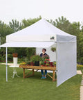 10x10 Pop Up Canopy Tent With No Tip Rolling Bag, Heavy Duty Instant Shelter Gazebo, 30 Sq Ft Extension Awning And 4 Zippered Removable Walls, UV And Water Resistant, White Commercial Outdoor Tent For Events set up in a garden.