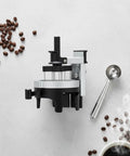 Premium Espresso Coffee Distributor And Tamper Leveler With Adjustable Rotary Depth And Twelve Prongs on a smooth surface with coffee beans