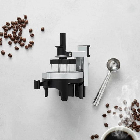 Premium Espresso Coffee Distributor And Tamper Leveler With Adjustable Rotary Depth And Twelve Prongs on a smooth surface with coffee beans