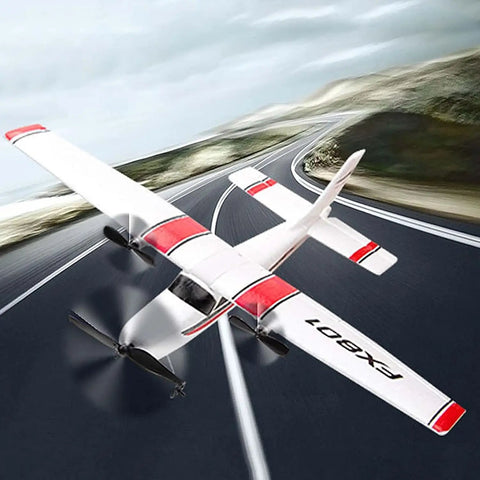 Beginner Friendly RC Plane With 2.4GHz 2 Channel Control, EPP Foam Glider in flight over a road, showcasing red and white design.