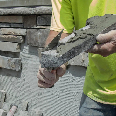 Pointing Trowel For Masonry And Mortar Finishing, Pro Grade For DIYers held by person applying mortar to stone wall.