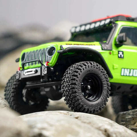 Close-up of Maverix MT RC Tires For 1 30 Scale Axial SCX30 34x12mm with dense tread blocks on rocky terrain