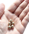 Hand holding brass ball cap nuts M4x0.7 thread pack of 10, decorative screw caps for furniture and lighting, sleek metal knob caps