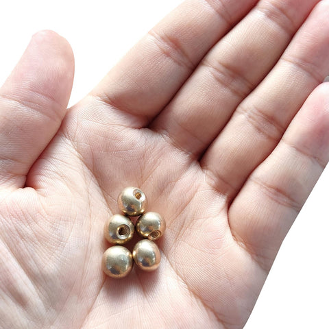 Hand holding brass ball cap nuts M4x0.7 thread pack of 10, decorative screw caps for furniture and lighting, sleek metal knob caps