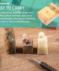 Adjustable Wood Carving Tool Clamp for Engraving with carved figures, shown on a workbench surface.
