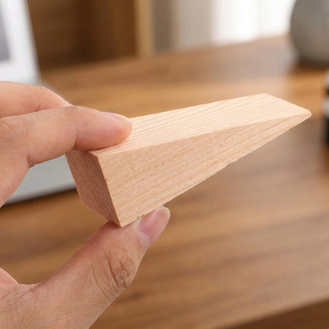Close-up of a single wedge from the 20 Pack Wooden Door Stop Wedges For Carpeted Floors Triangular Non Slip Heavy Duty Door Stoppers