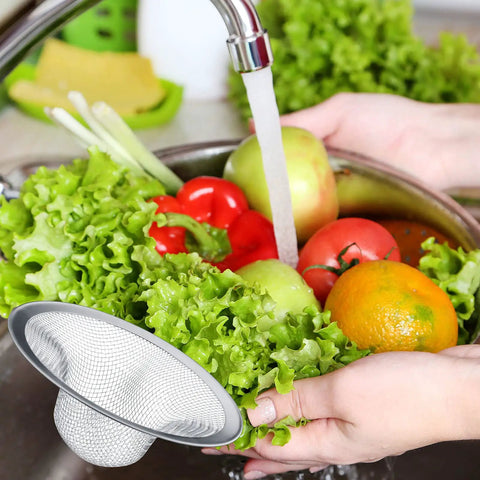 Stainless Steel Sink Strainer 12 Pack Heavy Duty Mesh Sieve Catches Food Gunk And Hair No Sweat Drain Catcher With Rust Proof Build That Nails Kitchen Cleanup For All Basins in a bowl with fresh vegetables.