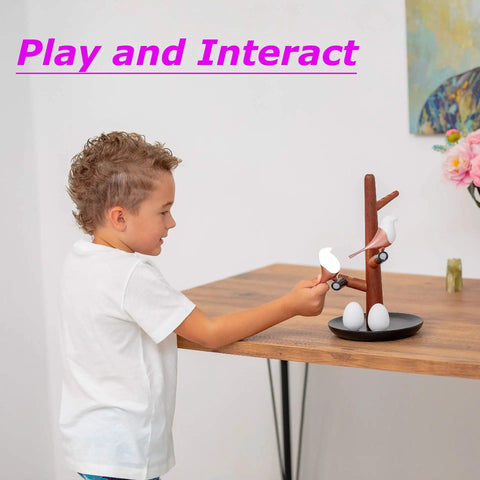Child playing with Tree Of Lyte Motion Sensor Bird Night Light Dimmable Wireless Rechargeable Modern Desk Rose Gold Wood Lamp