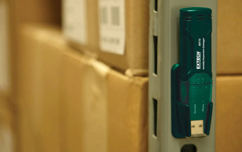 Grab And Go Humidity And Temperature USB Data Logger With 16,000 Readings Memory, mounted on a metal shelf in a storage room.