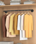 Built Like A Tank Wall Mounted Clothes Rack 3 Pack Black Industrial Pipe Garment Rail with hanging garments in closet.