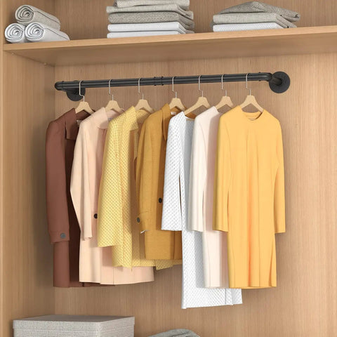 Built Like A Tank Wall Mounted Clothes Rack 3 Pack Black Industrial Pipe Garment Rail with hanging garments in closet.