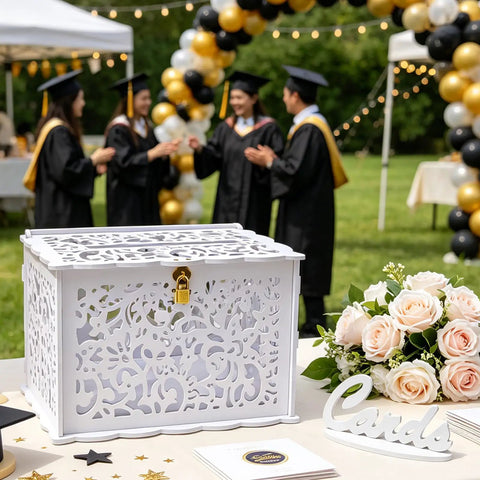 Slick White Silhouette Wedding Card Box With Lock And Slot on table, surrounded by roses and graduates in background.