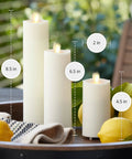 Outdoor Slim Pillar Flameless Led Candles Set Of 3 Ivory With Moving Flame on patio table with lemons and cloth