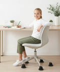 Child sitting on office chair with 8 Pack Furniture Caster Cups With Rubber Bed Stoppers For All Furniture Wheels, Chair Coasters And Floor Protectors, Vacuum Adsorption Design To Stop Rolling And Prevent Scratches On Sofas, Beds, Pianos.