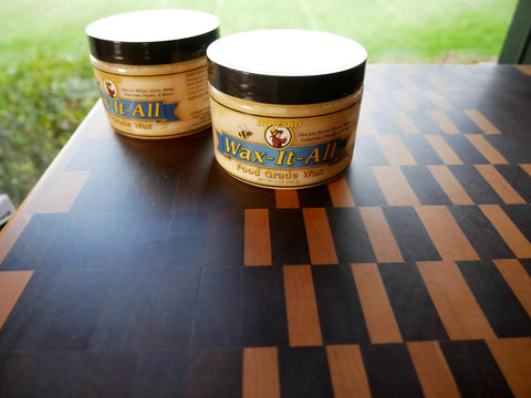 Real Deal Food Grade Beeswax Wood Polish And Cutting Board Wax, Zero Hustle Multi Surface Protectant That Keeps Kitchen Counters And Dining Tables Lookin Fresh, Smooth Finish Coating, Nine Oz Jar on a wooden cutting board.
