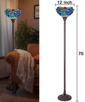 Tiffany Style Stained Glass Torchiere Floor Lamp 70 Inches Tall With Blue Dragonfly Accent next to a couch in a living room