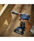 Worker using the 18V All In One Impact Driver And Wrench Kit With One Quarter Inch Hex Shank And One Half Inch Square Drive on wood.