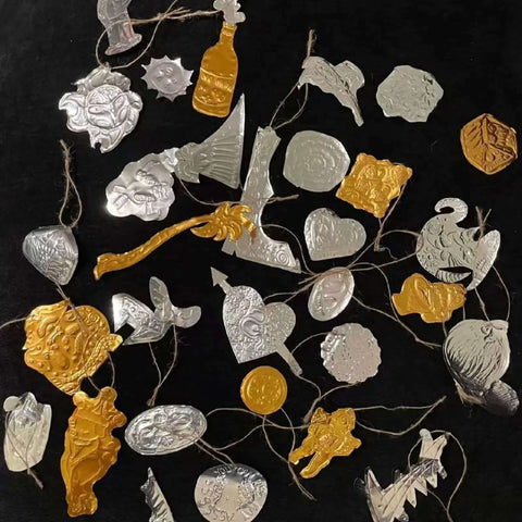 Assorted gold and silver embossed shapes from Gold Tin Foil Craft Kit with 15 dual-sided aluminum foil sheets and accessories.