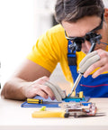 Technician wearing Moisture Wicking Cotton Finger Cots And Toe Sleeves Set For Glove Comfort while working on electronics.