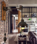 Badass Industrial Pulley Wall Sconce Featuring Solid Black Iron Rope Lighting with wooden mount in living room decor.