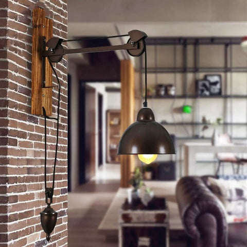 Badass Industrial Pulley Wall Sconce Featuring Solid Black Iron Rope Lighting with wooden mount in living room decor.