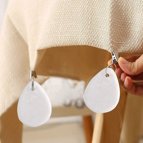12 Piece Teardrop Marble Tablecloth Weights With Metal Clips White for indoor outdoor use clipping on beige linen