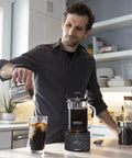 Man using Dorothy Electric Rapid Cold Brewer for Home Coffee Making Quick Cold Brew in Just 15 Minutes No More 12 to 24 Hour Wait Tornado Stir Technology Delivers Smooth Cafe Style Cold Brew at Home on kitchen counter.