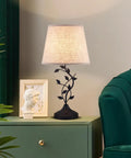 Vintage Tree Branch Base Table Lamp With Beige Shade USB A And USB C Charging Ports on a bedside table in living room.